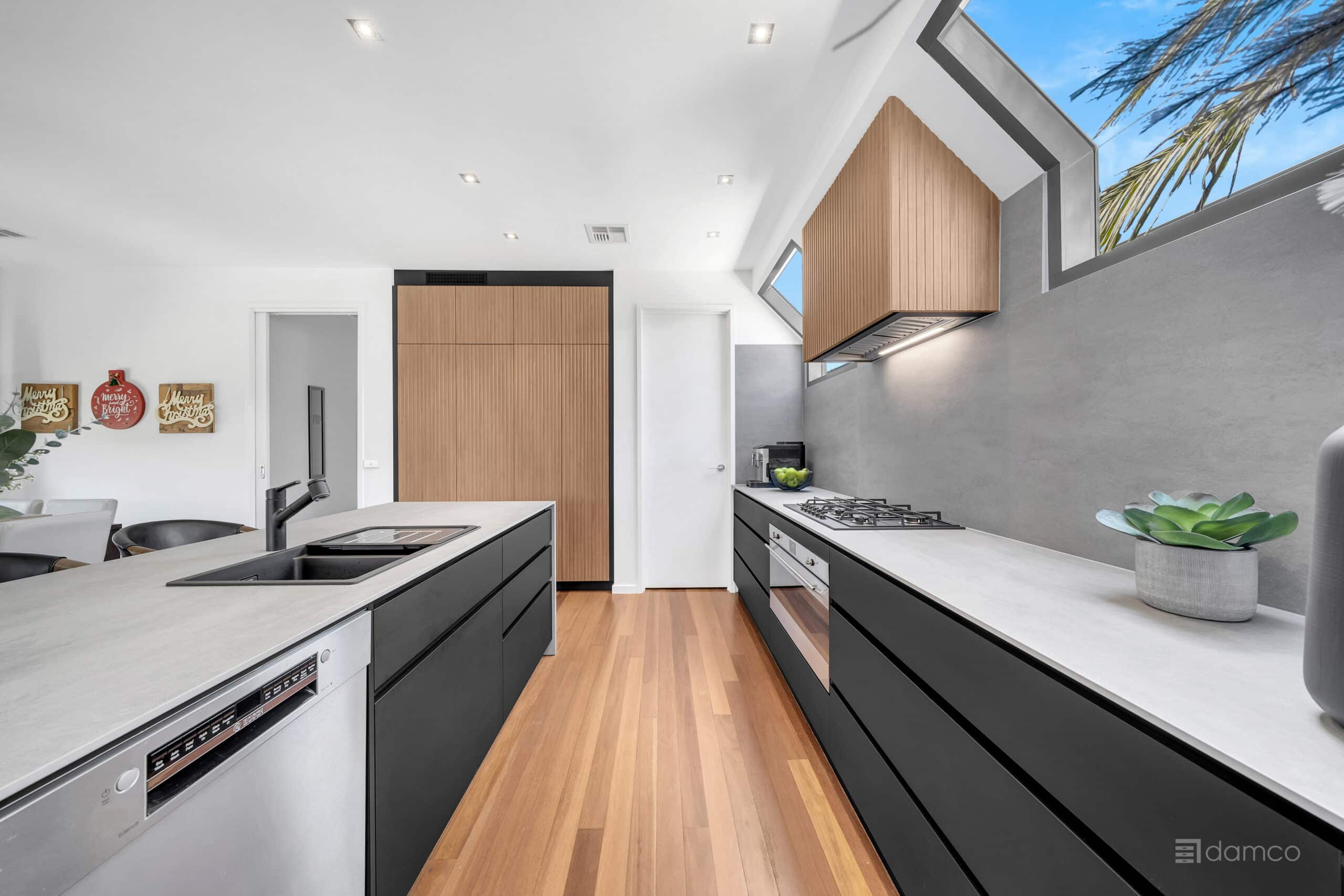 handleless matte black kitchen cabinets with SMEG appliances in Parkdale